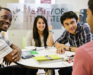 Students sat around a table filling out an application