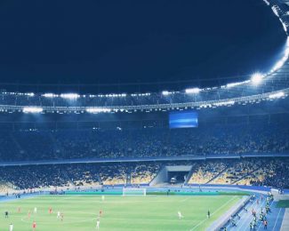 Floodlit football stadium night game atmosphere